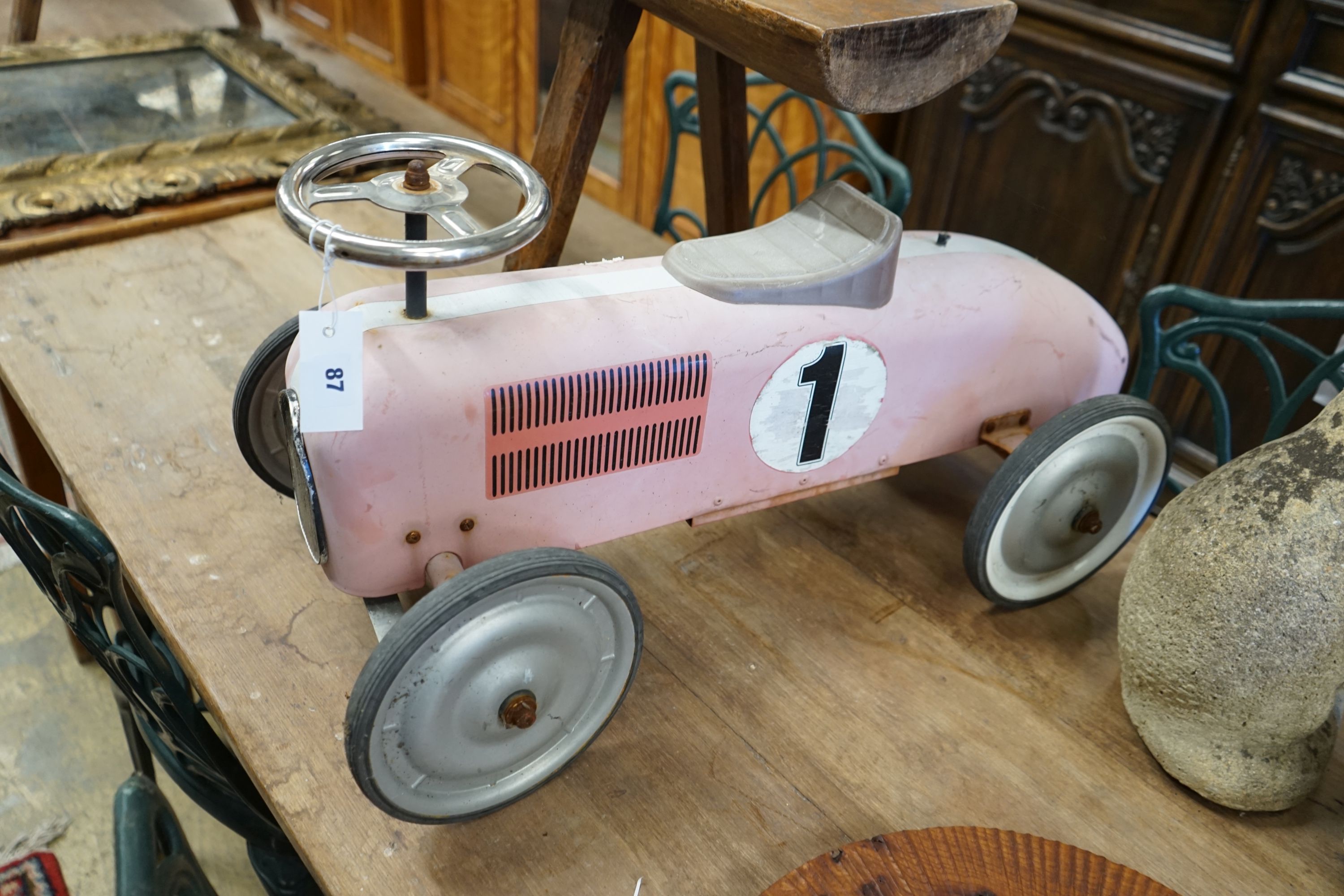 A child's sit-on toy racing car